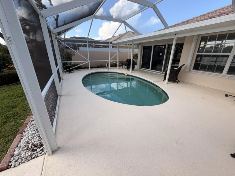 Screen enclosure and pool deck after cleaning by AquaFlow Pro Wash
