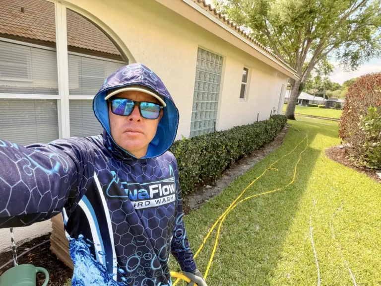 Adam, owner of AquaFlow Pro Wash, on a house washing job in Port St. Lucie