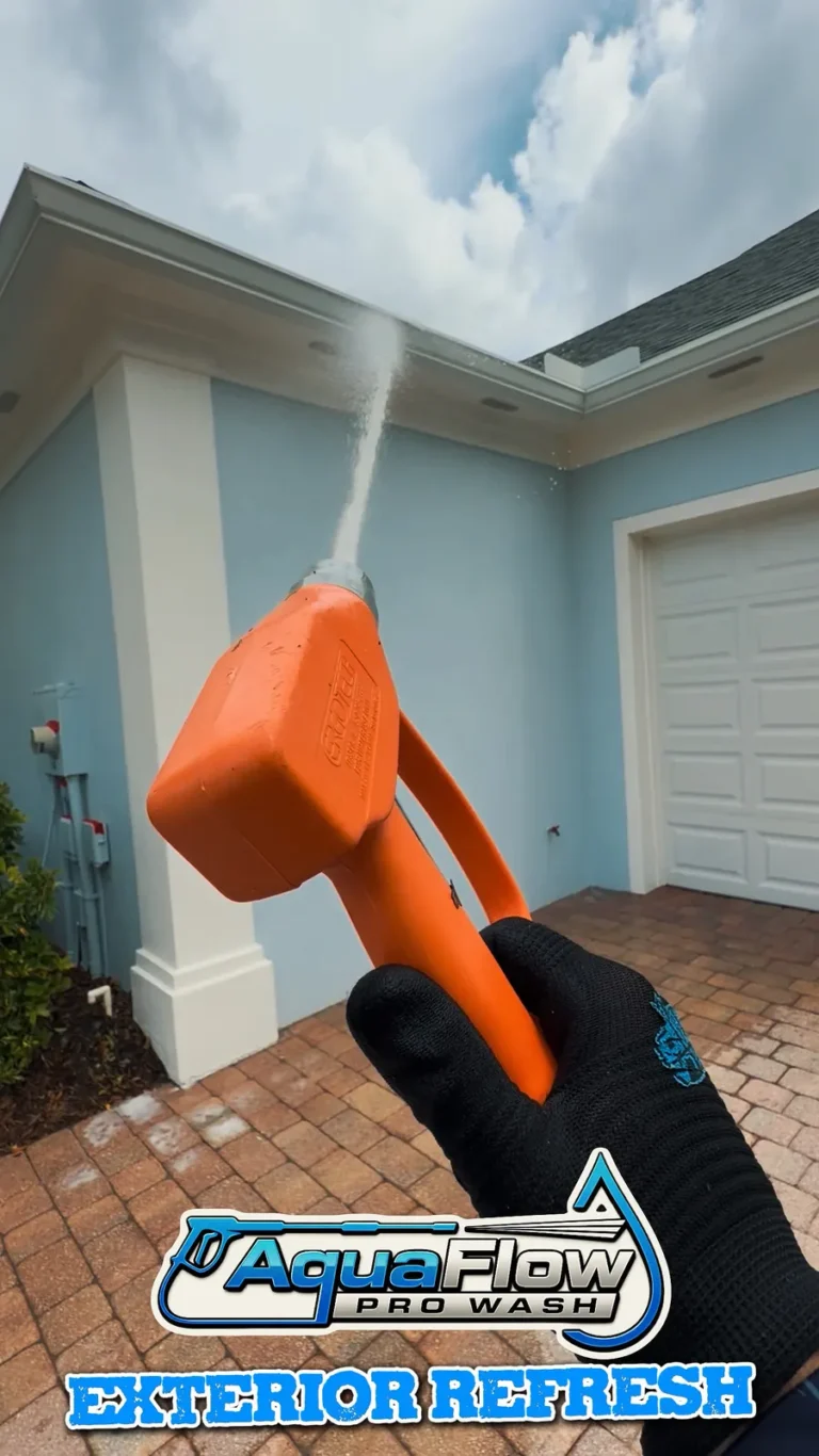 AquaFlow Pro Wash spray application on a home exterior