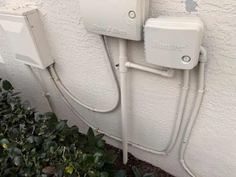The same stucco wall and irrigation controllers after house washing