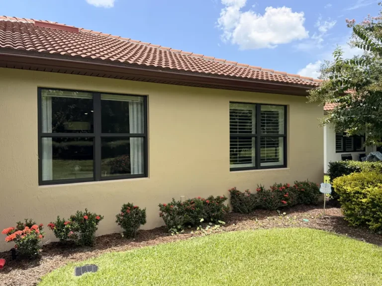 Clean yellow stucco home with tile roof and landscaping in Port St. Lucie