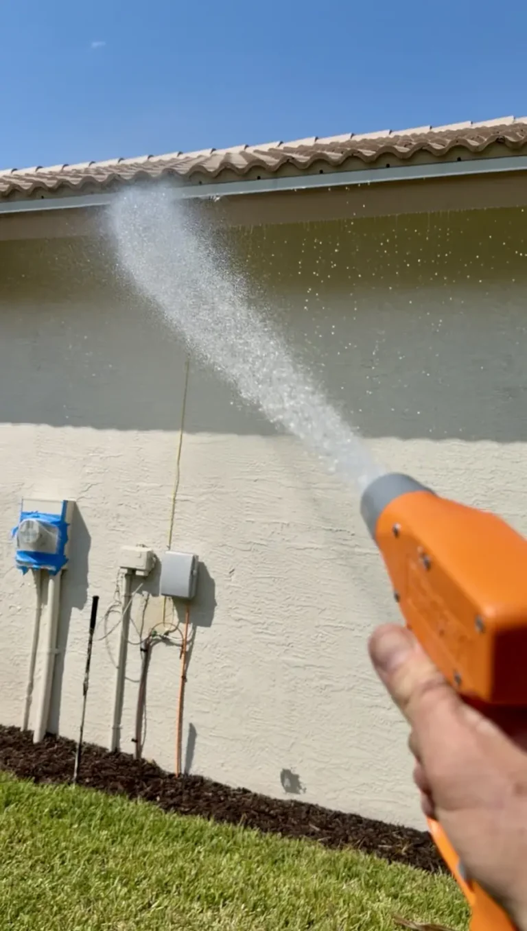 AquaFlow soft-wash application on a stucco wall of a Port St. Lucie home