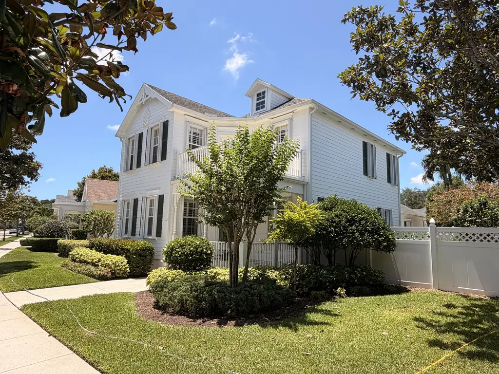Front of a two-story home with clean siding and landscaping